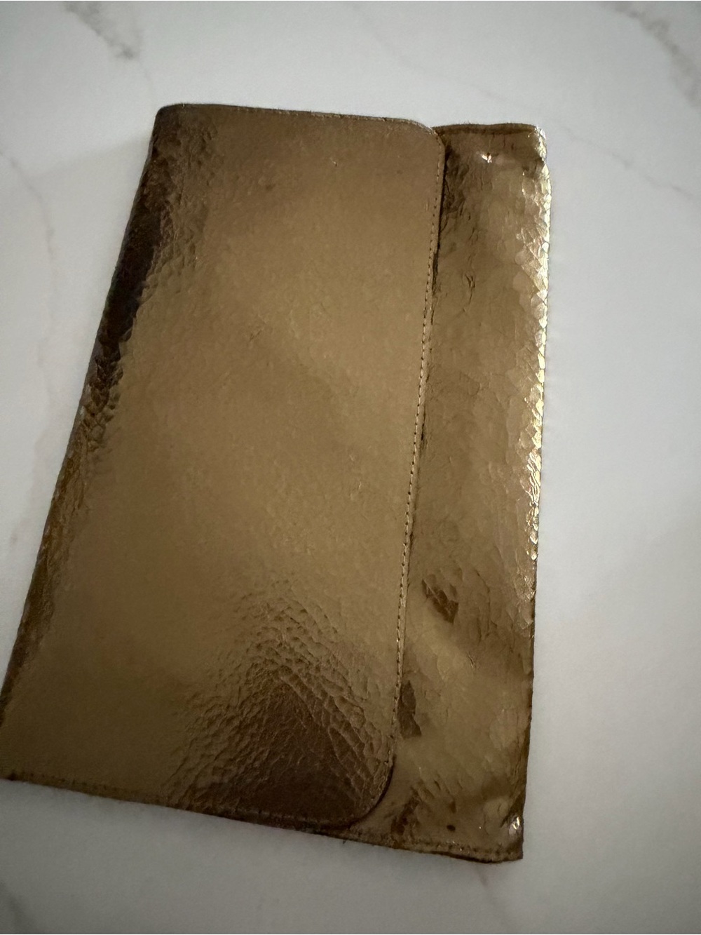 Kestrel Gold Casual Clutch with contrasting purple animal print interior.